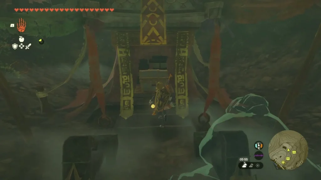 Gate covered in red banners with a chest inside the south cave