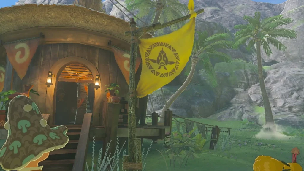 Yellow village flag hanging beside a thatched house Yellow village flag hanging beside a thatched house