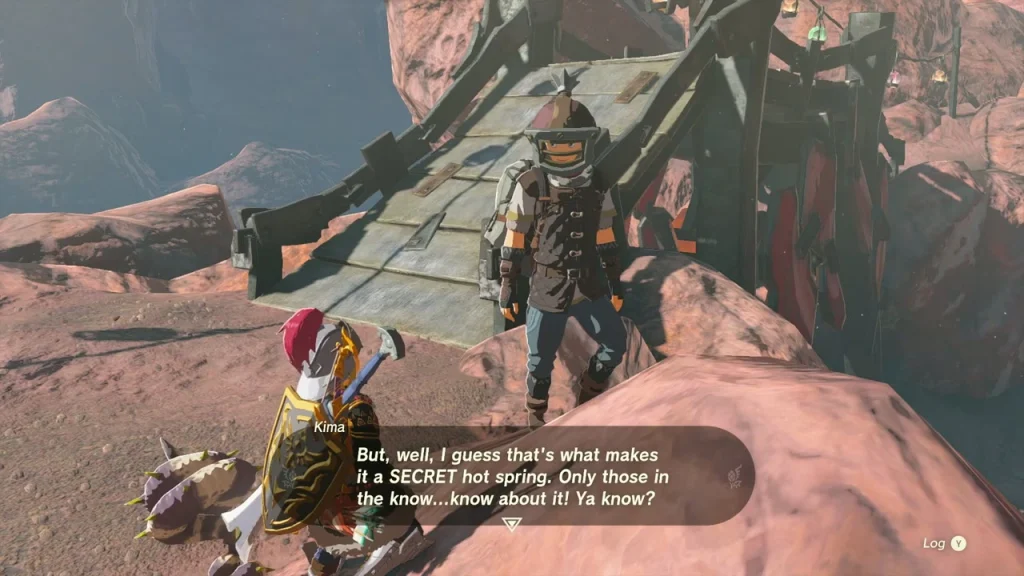Kima beside the steel-braced bridge ramp
