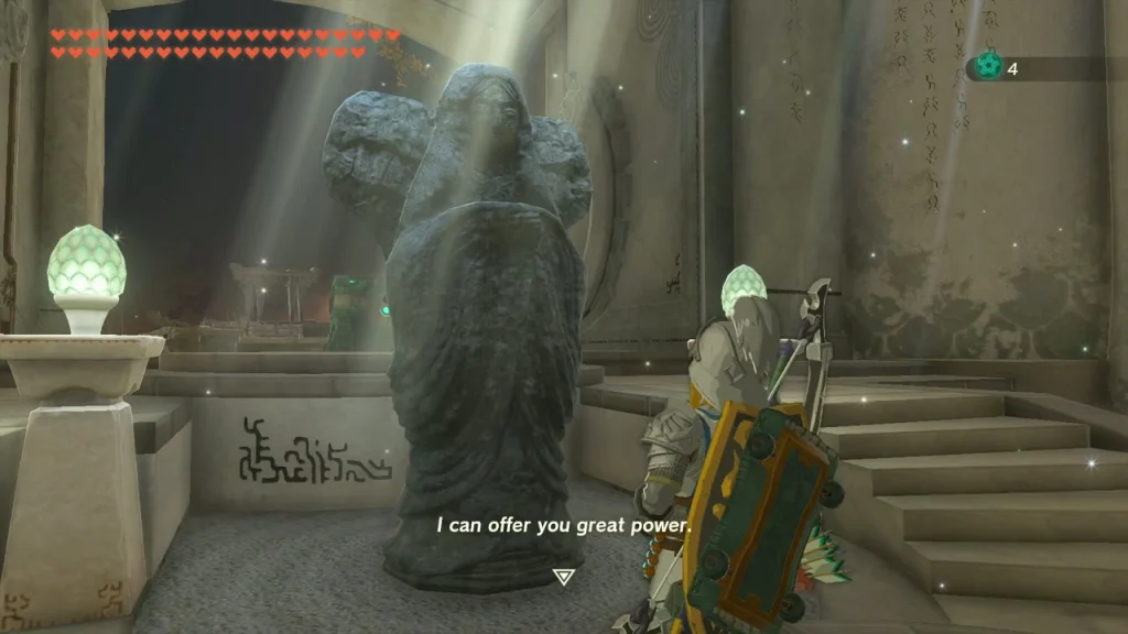 Goddess statue lit by a beam of light between two lamps