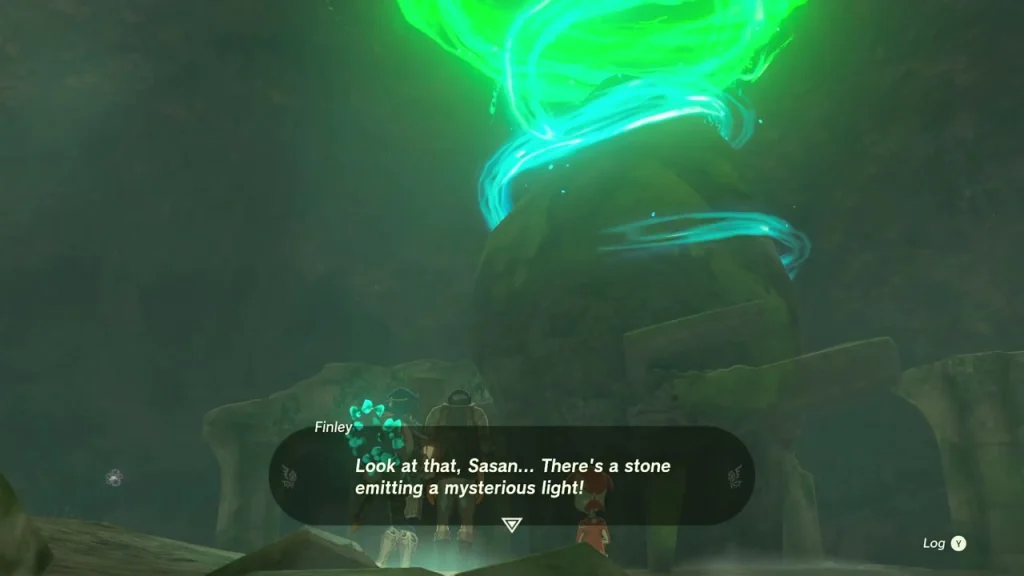 Green beam of light rising from the shrine at the far end of the cave