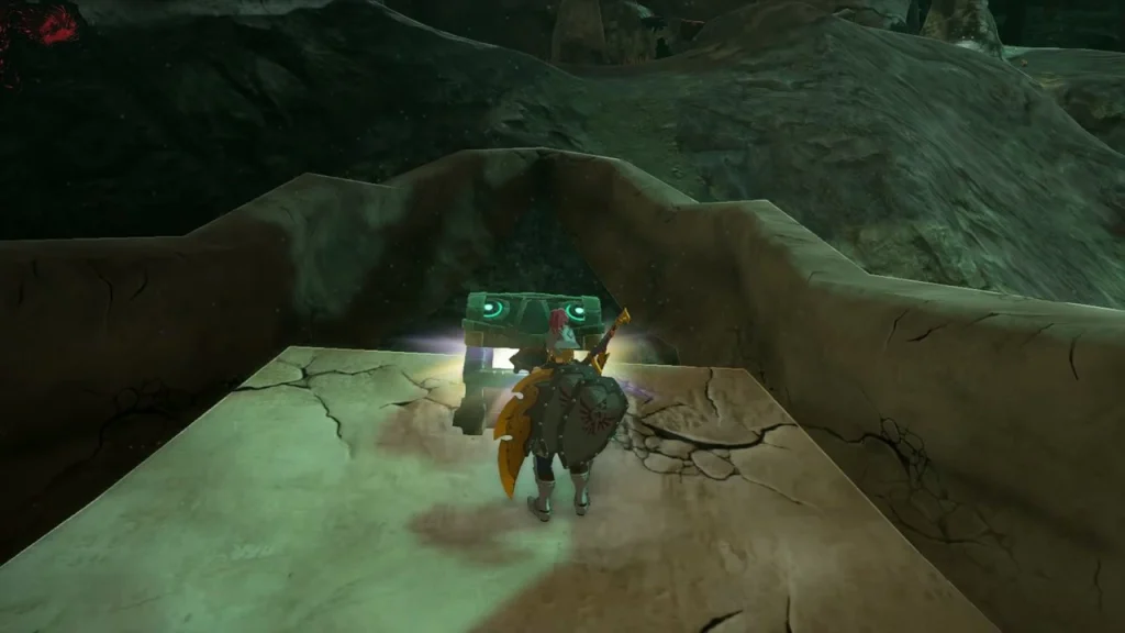 Green chest on a cracked stone ledge below an arched rock Green chest on a cracked stone ledge below an arched rock
