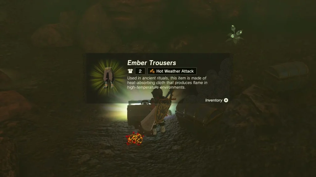 Ember Trousers item box held above the chest in the dark chest-filled cave Ember Trousers item box held above the chest in the dark chest-filled cave