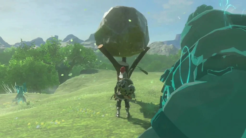 Boulder held up beside a grassy mound near a stand Boulder held up beside a grassy mound near a stand