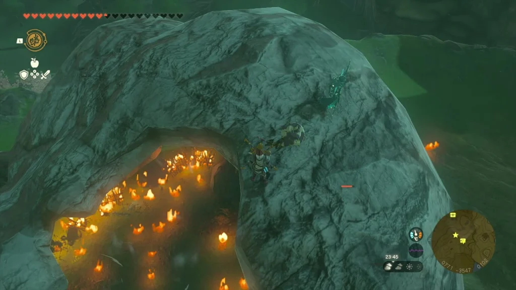 Cave mouth with a burning Bokoblin camp Cave mouth with a burning Bokoblin camp