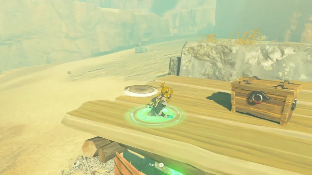 Wooden plank platform with a chest on the cliff above the sand Wooden plank platform with a chest on the cliff above the sand