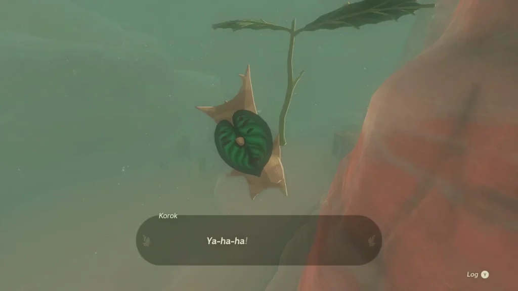 Korok hanging from a leaf beside a red rock face Korok hanging from a leaf beside a red rock face