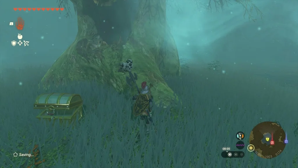 Treasure chest in tall misty grass at the foot of a huge tree near Lake Saria