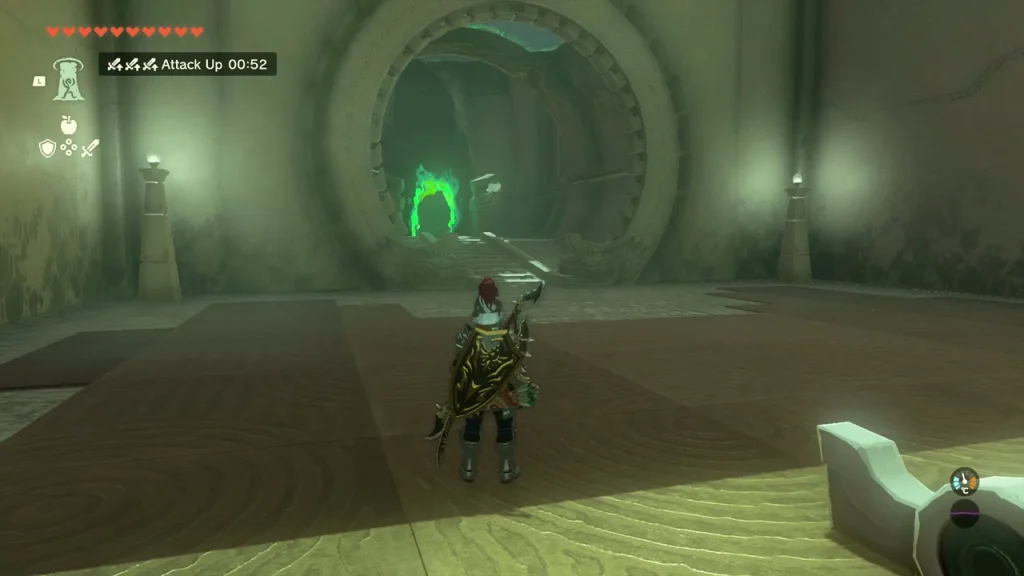 First chamber of Musanokir Shrine with a stone floor and a round green-lit doorway ahead