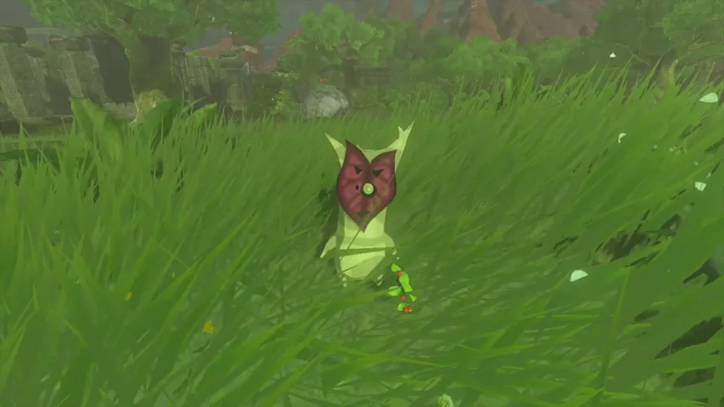 Korok standing in tall grass beside a ruined wall