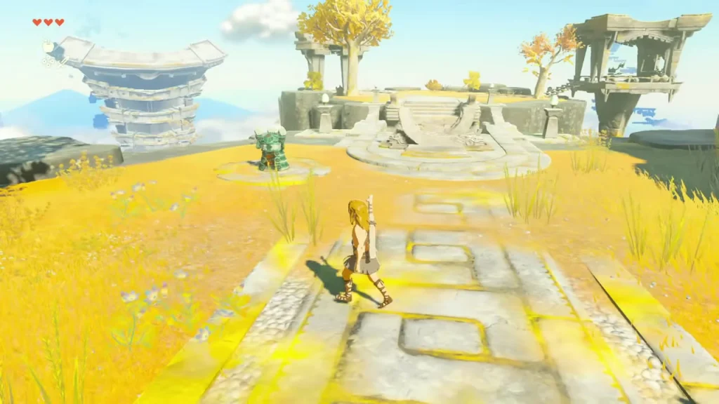 Stone path across yellow grass leading to the Steward Construct beside the ruins Stone path across yellow grass leading to the Steward Construct beside the ruins