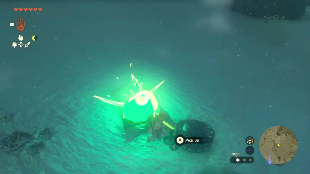 Glowing Zonai device being picked up from the snow Glowing Zonai device being picked up from the snow