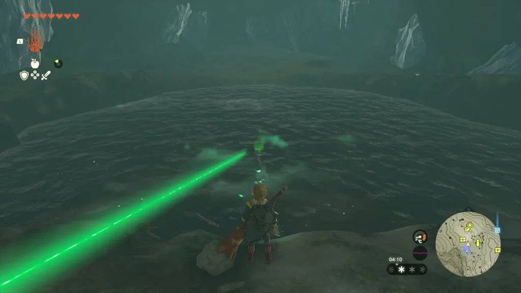 Green beam pointing across the cold lake inside the cave Green beam pointing across the cold lake inside the cave