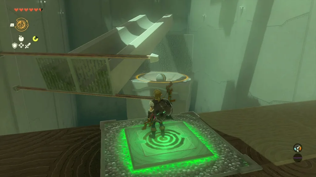 Green floor switch beside a ball resting on rails Green floor switch beside a ball resting on rails