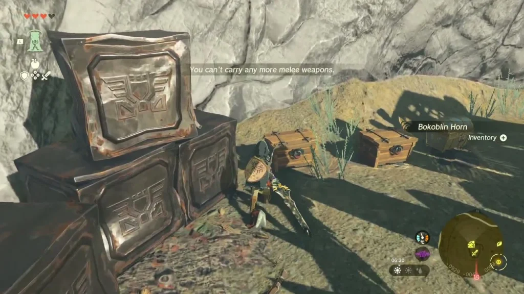 Three chests beside stacked metal crates at the foot of a pale cliff inside the fort Three chests beside stacked metal crates at the foot of a pale cliff inside the fort