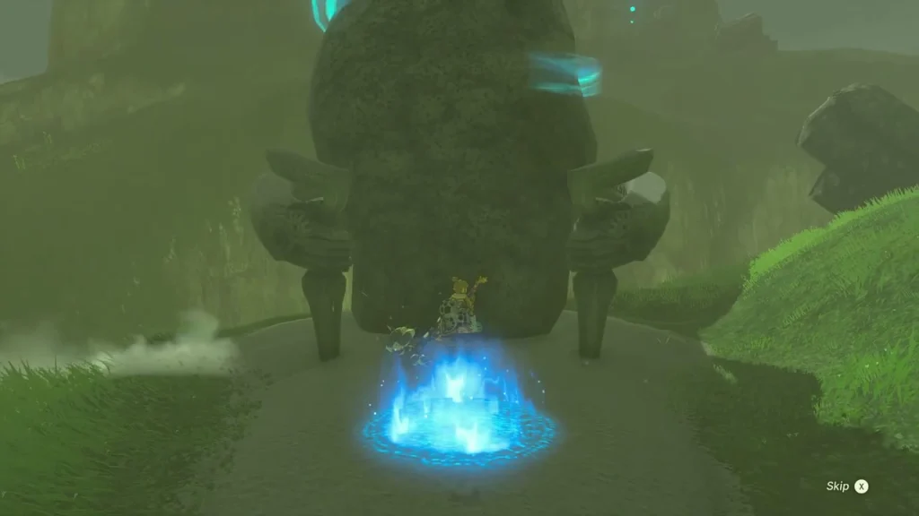 Blue travel pad in front of the stone entrance above Kakariko Village