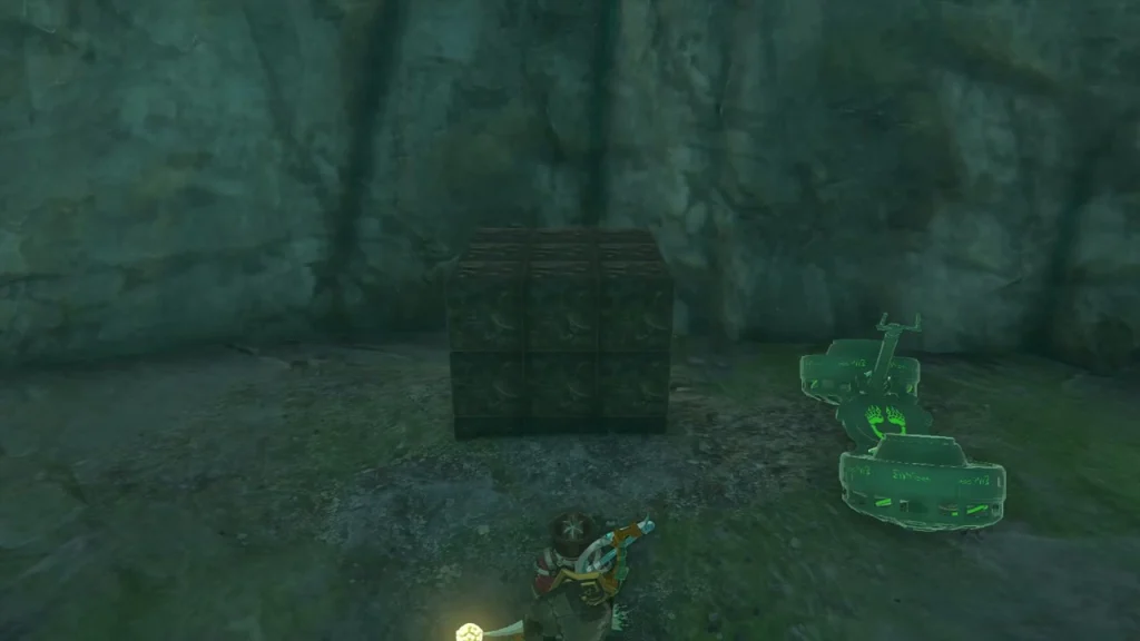 Stone cube beside a green device on a platform Stone cube beside a green device on a platform