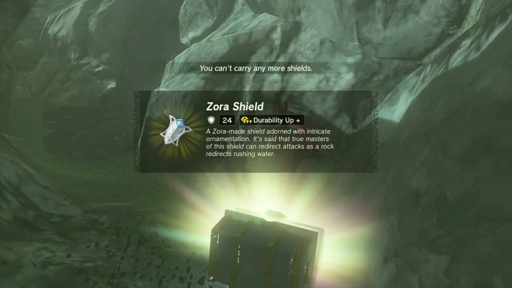 Zora Shield item box above a glowing chest in a rocky hollow Zora Shield item box above a glowing chest in a rocky hollow