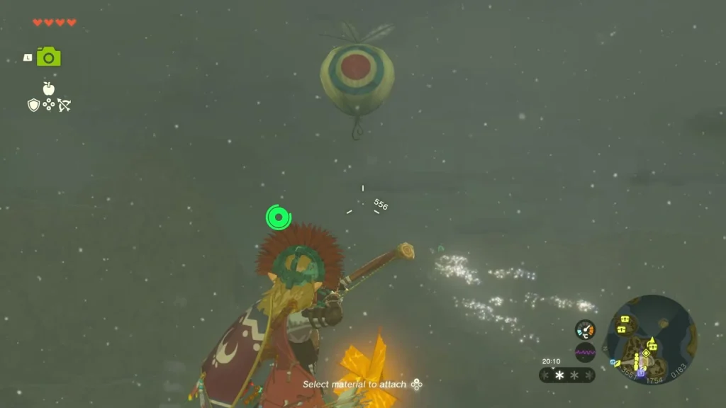 Red balloon floating above a tall rock pillar with an arrow nocked at it Red balloon floating above a tall rock pillar with an arrow nocked at it
