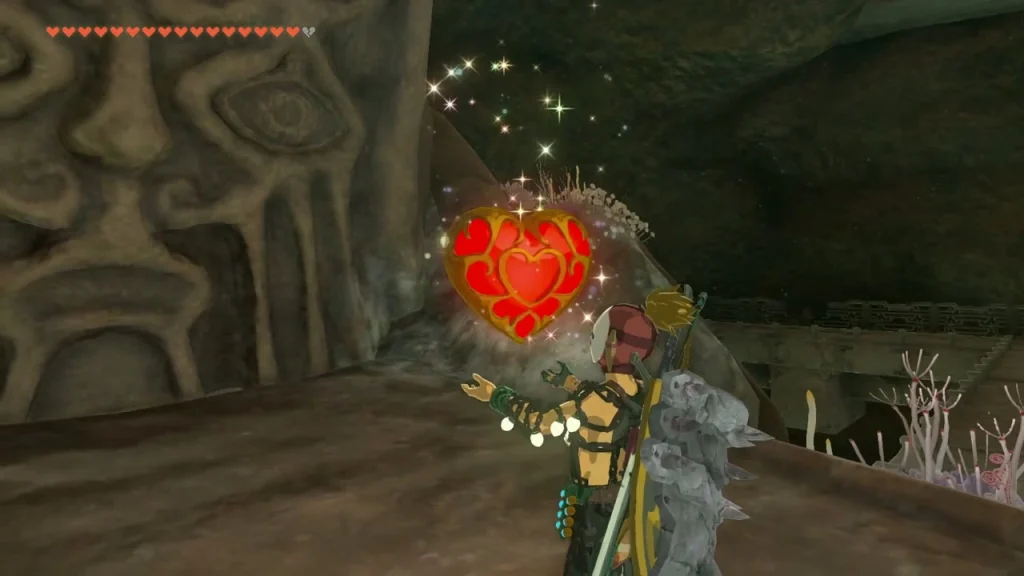 Heart Container held up beside the carved Bargainer Statue face
