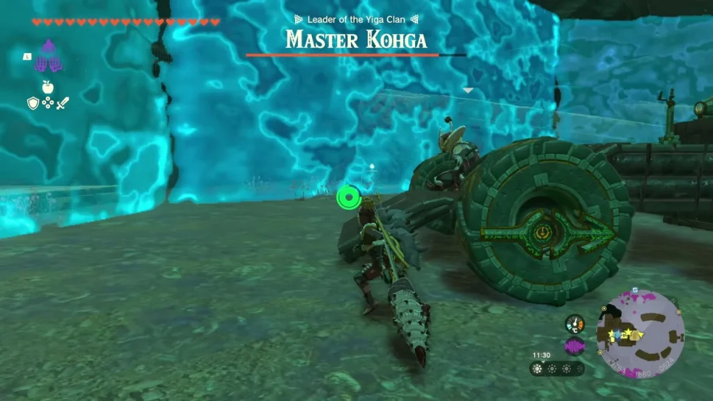 Master Kohga in his wheeled machine beside a blue energy wall