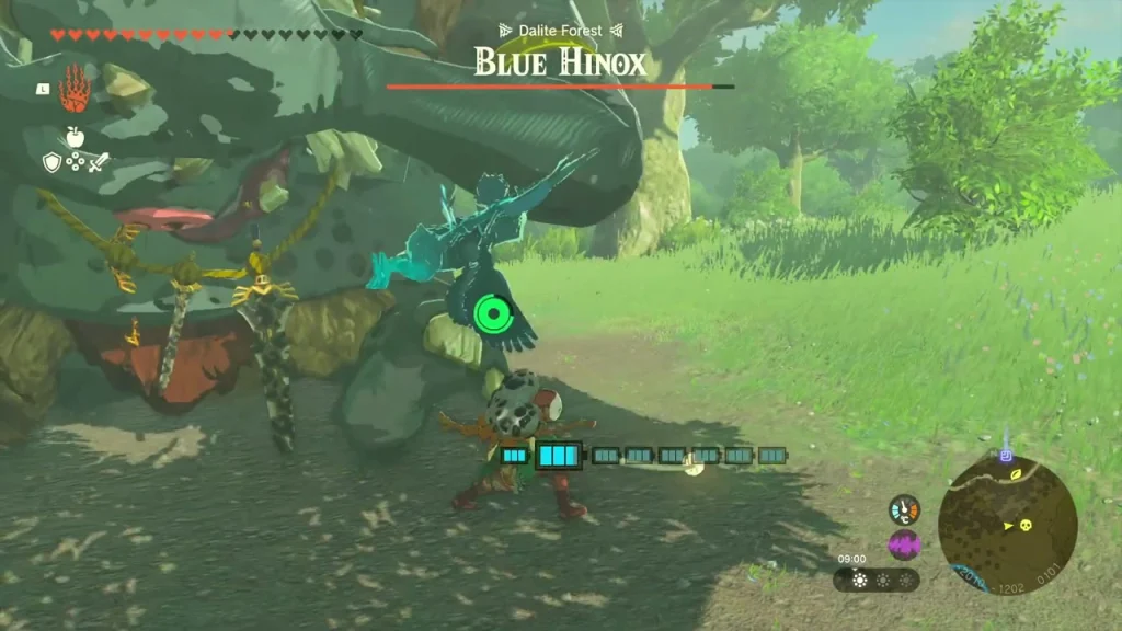 Blue Hinox in a grassy clearing beside a large tree