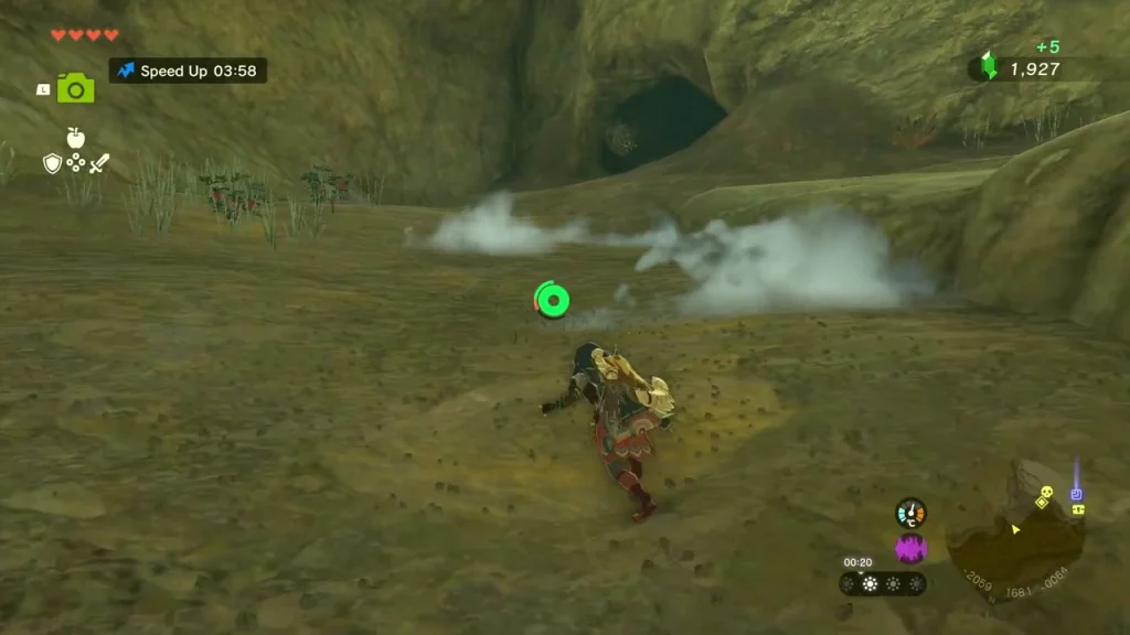 Cave mouth on the sandy canyon floor with a puff of smoke drifting in front of the entrance Cave mouth on the sandy canyon floor with a puff of smoke drifting in front of the entrance