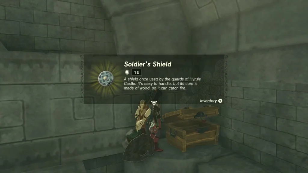 Soldier's Shield item box held up beside the open chest in the stone chamber Soldier's Shield item box held up beside the open chest in the stone chamber