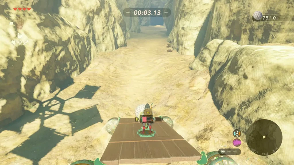 Vehicle with a ball on its deck racing down the canyon, distance counter on screen Vehicle with a ball on its deck racing down the canyon, distance counter on screen