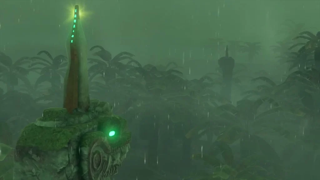 Carved stone serpent head with a green eye and a tall metal spike in the jungle rain Carved stone serpent head with a green eye and a tall metal spike in the jungle rain