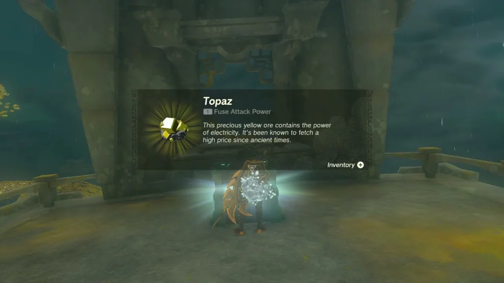 Topaz item box held above a chest beside a stone pillar Topaz item box held above a chest beside a stone pillar