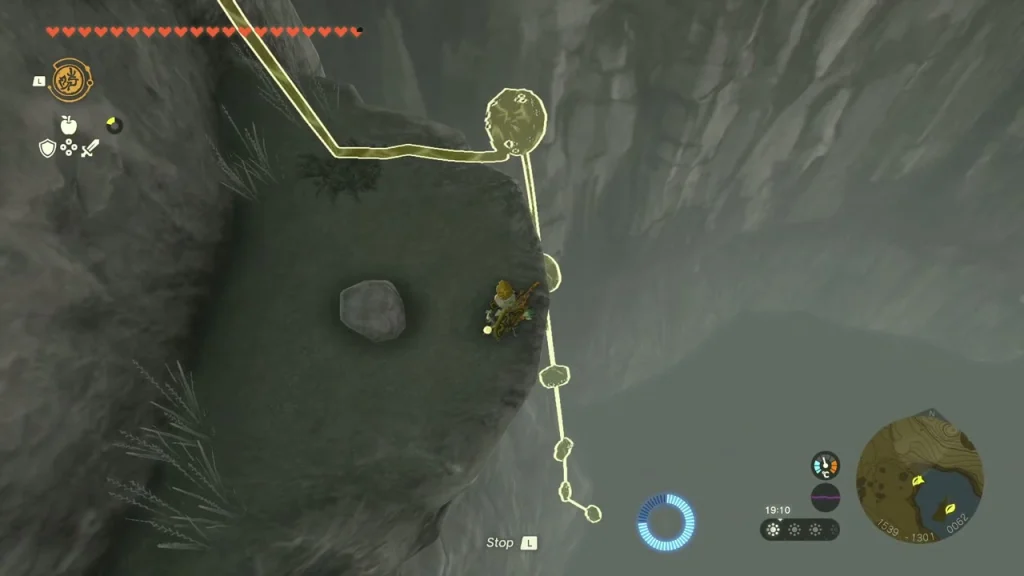 Cliff face with a boulder to lift and a climbing route marked Cliff face with a boulder to lift and a climbing route marked