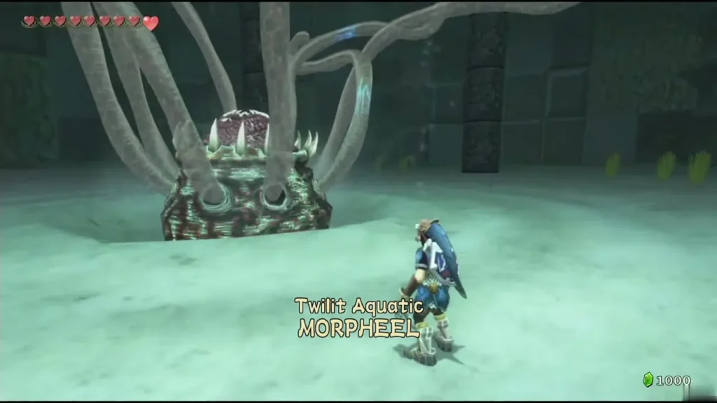 Morpheel's name card in its sandy arena, with its tentacles rising behind it Morpheel's name card in its sandy arena, with its tentacles rising behind it
