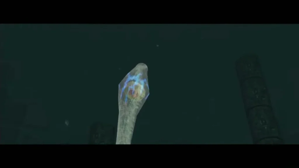 Glowing eye inside one of Morpheel's tentacles rising from the sand Glowing eye inside one of Morpheel's tentacles rising from the sand