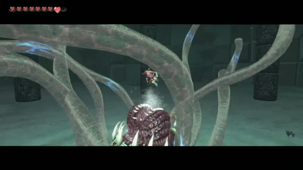 Link in the arena beneath Morpheel's tentacles, which wave around its open mouth Link in the arena beneath Morpheel's tentacles, which wave around its open mouth