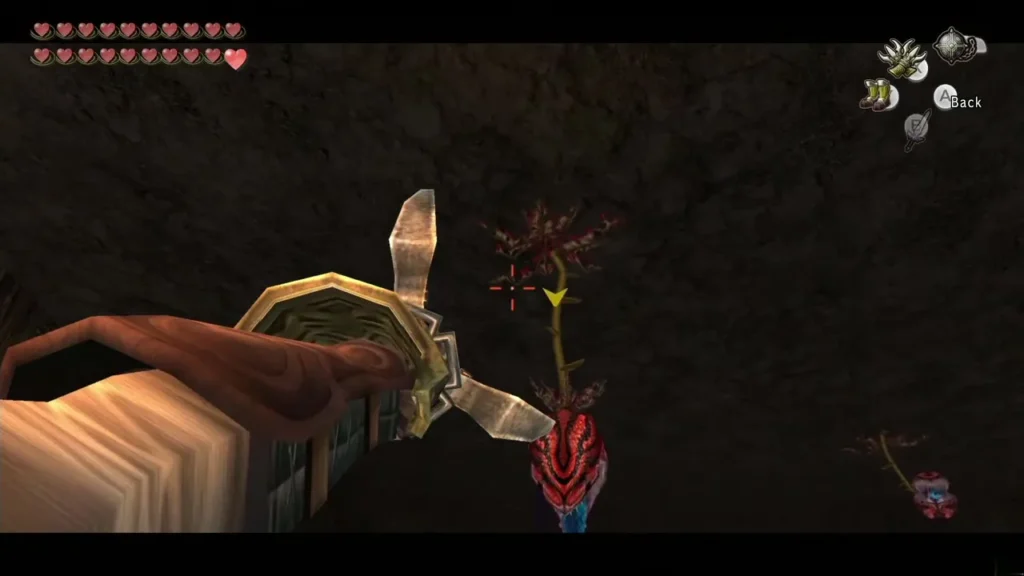 Link aiming the Gale Boomerang at a Baba Serpent hanging from the ceiling