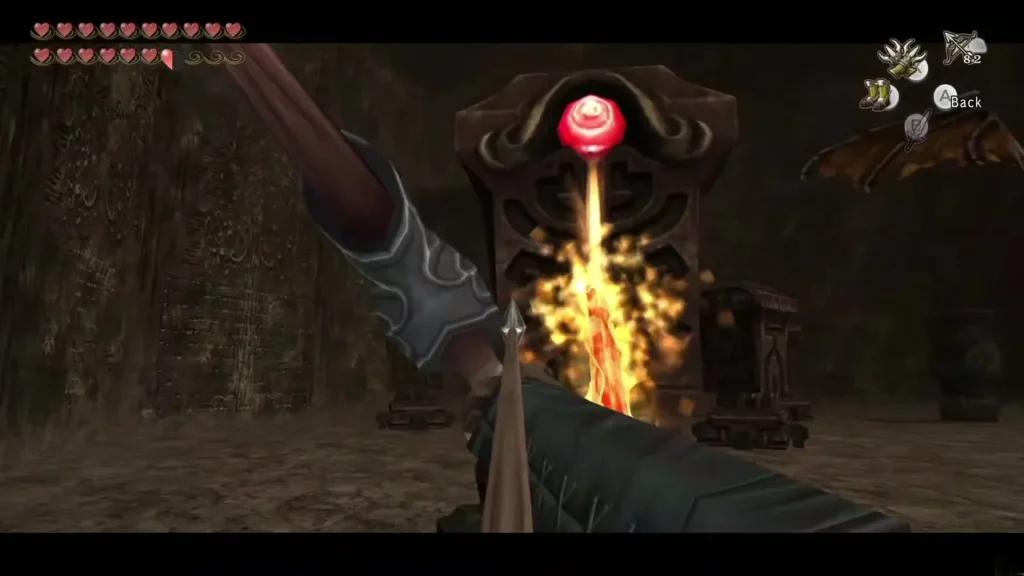 Link's bow aimed at a Beamos statue on floor 31 with an arrow flying