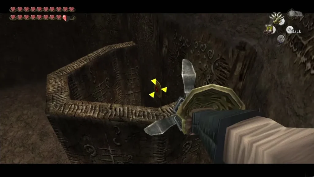 The Clawshot hooked into a wall grate beside a stone ledge