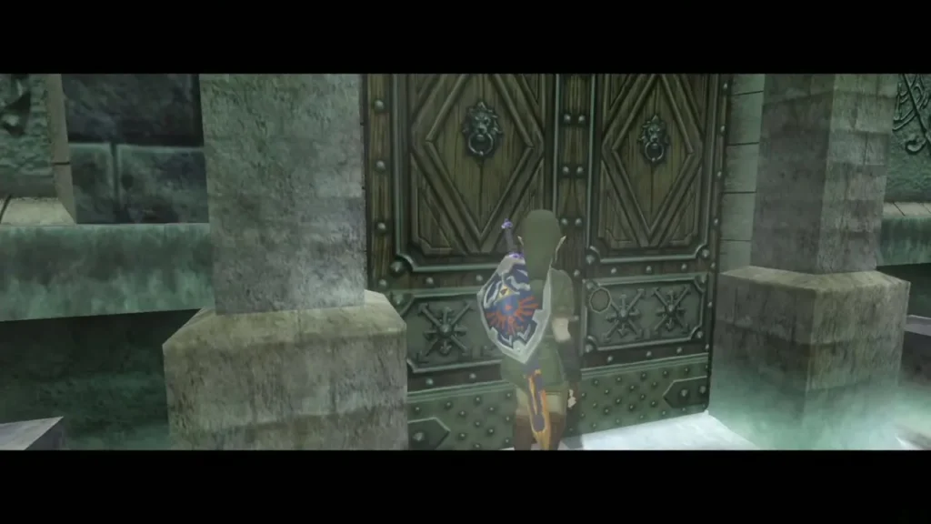 Link at the snowy Snowpeak Ruins entrance doors with the Hylian Shield Link at the snowy Snowpeak Ruins entrance doors with the Hylian Shield
