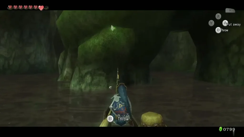 A Piece of Heart glowing on the mossy ledge of the rock arch, seen from the rowboat A Piece of Heart glowing on the mossy ledge of the rock arch, seen from the rowboat