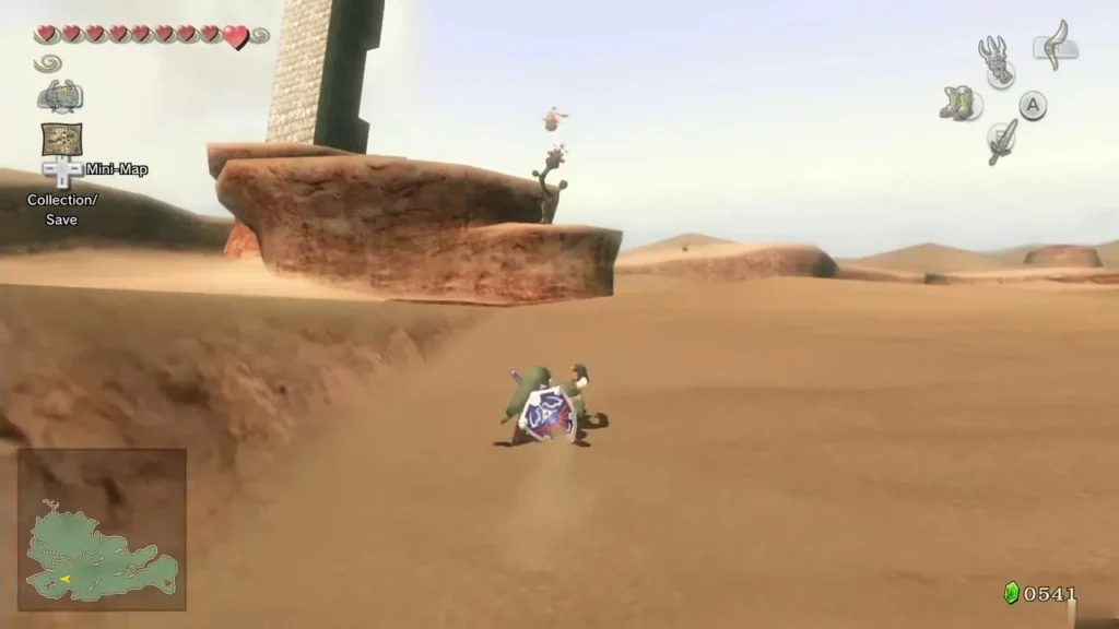 Link walking across desert sand below a raised rock ledge with a stone tower behind it