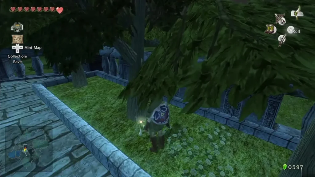 Link chasing the glowing golden ladybug through grass beside a tree and a stone wall