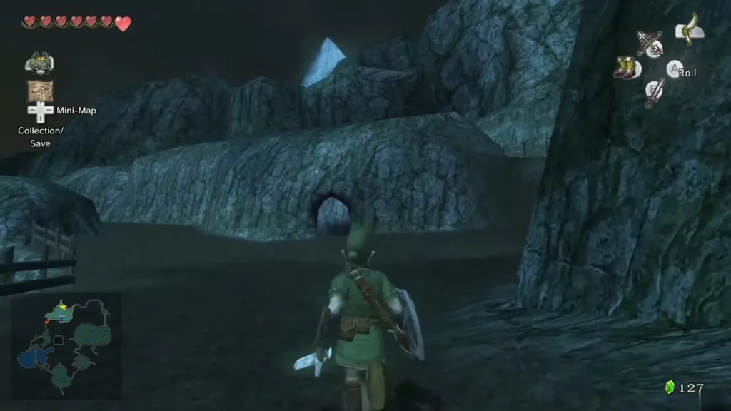 Link facing a rocky wall with a cave opening in Hyrule Field at night