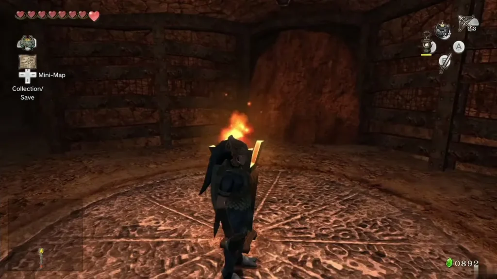 Link standing beside a lit torch in a round cave room Link standing beside a lit torch in a round cave room