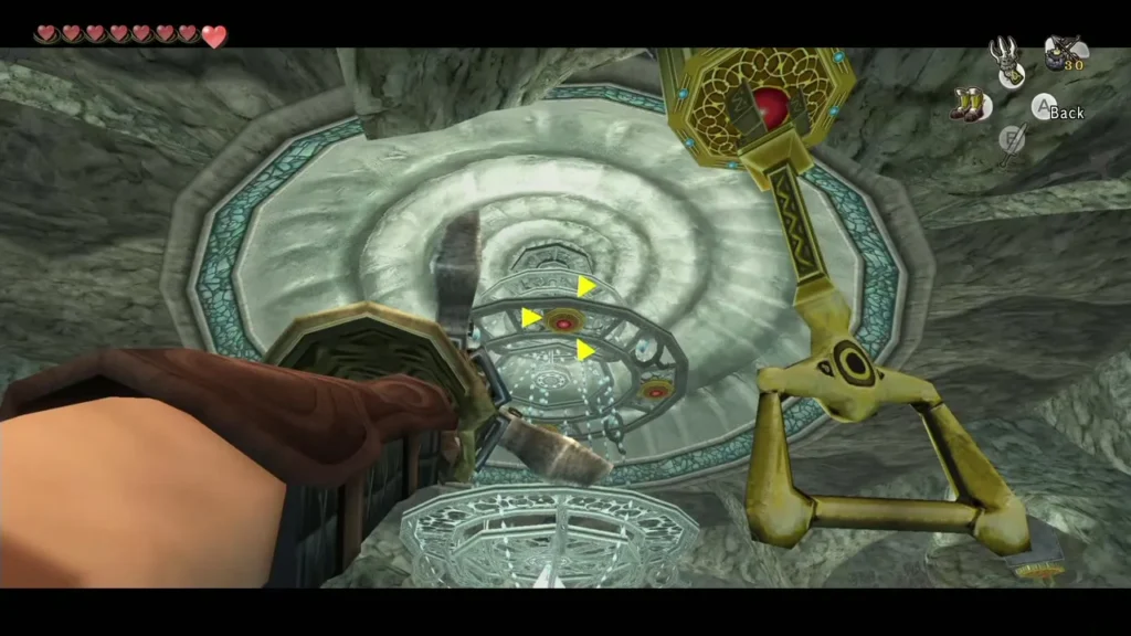 Link aiming the Clawshot at a target above the chandelier in the round chamber Link aiming the Clawshot at a target above the chandelier in the round chamber