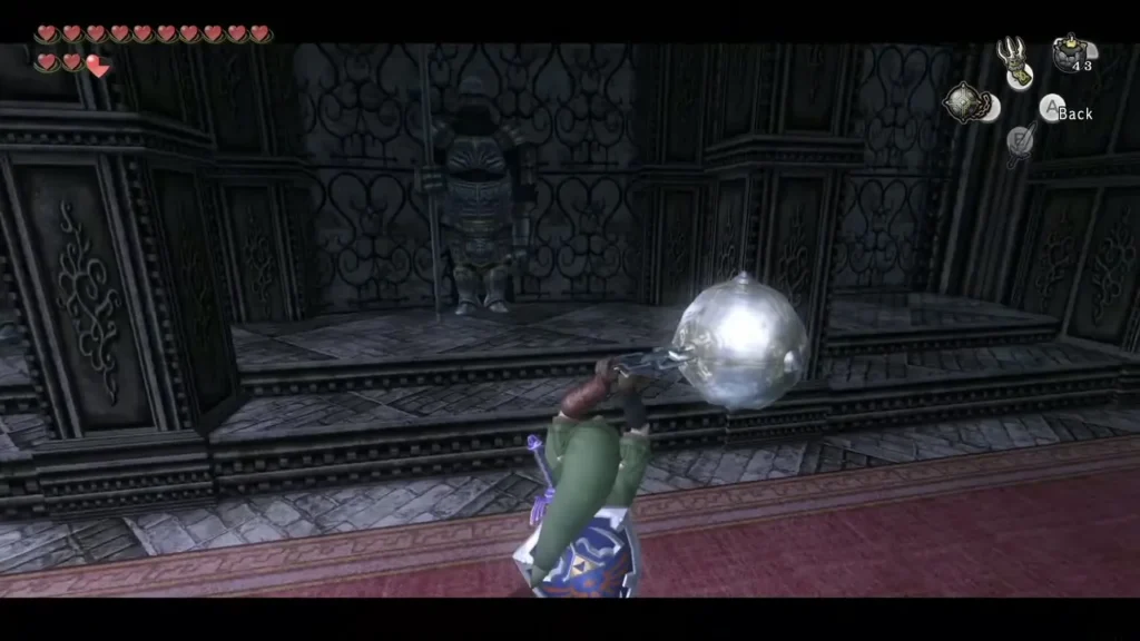 Link swinging the Ball and Chain toward a soldier statue in a stone hall Link swinging the Ball and Chain toward a soldier statue in a stone hall
