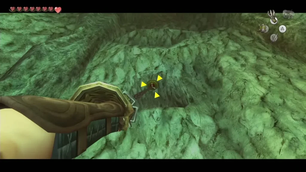 Clawshot aimed at yellow targets on a rock wall in the Lakebed Temple Clawshot aimed at yellow targets on a rock wall in the Lakebed Temple