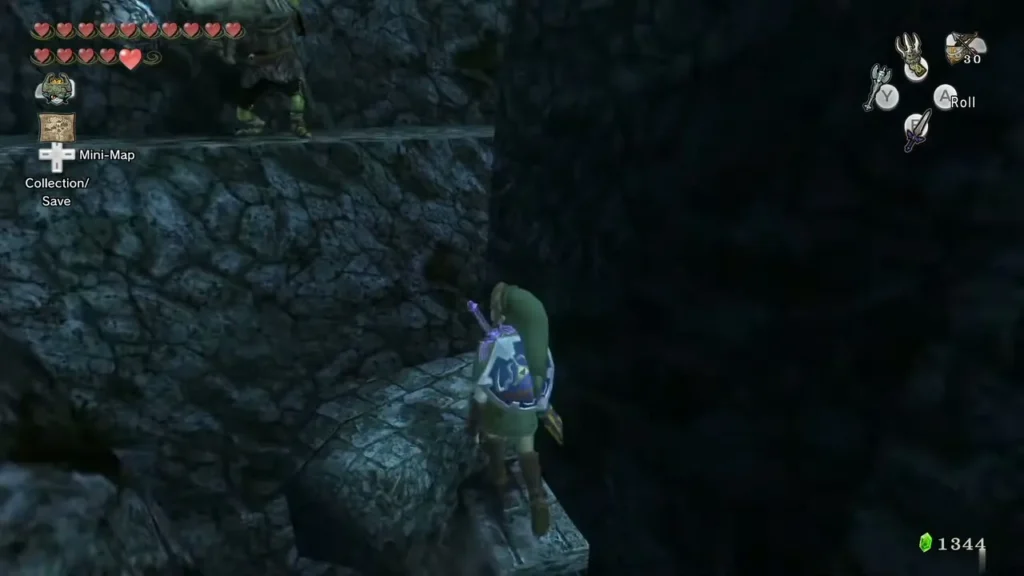 Link climbing a rock ledge up toward a higher path in the ruins