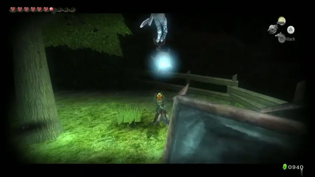 A Poe floating beside a tree on the raised ground inside a wooden fence at night A Poe floating beside a tree on the raised ground inside a wooden fence at night